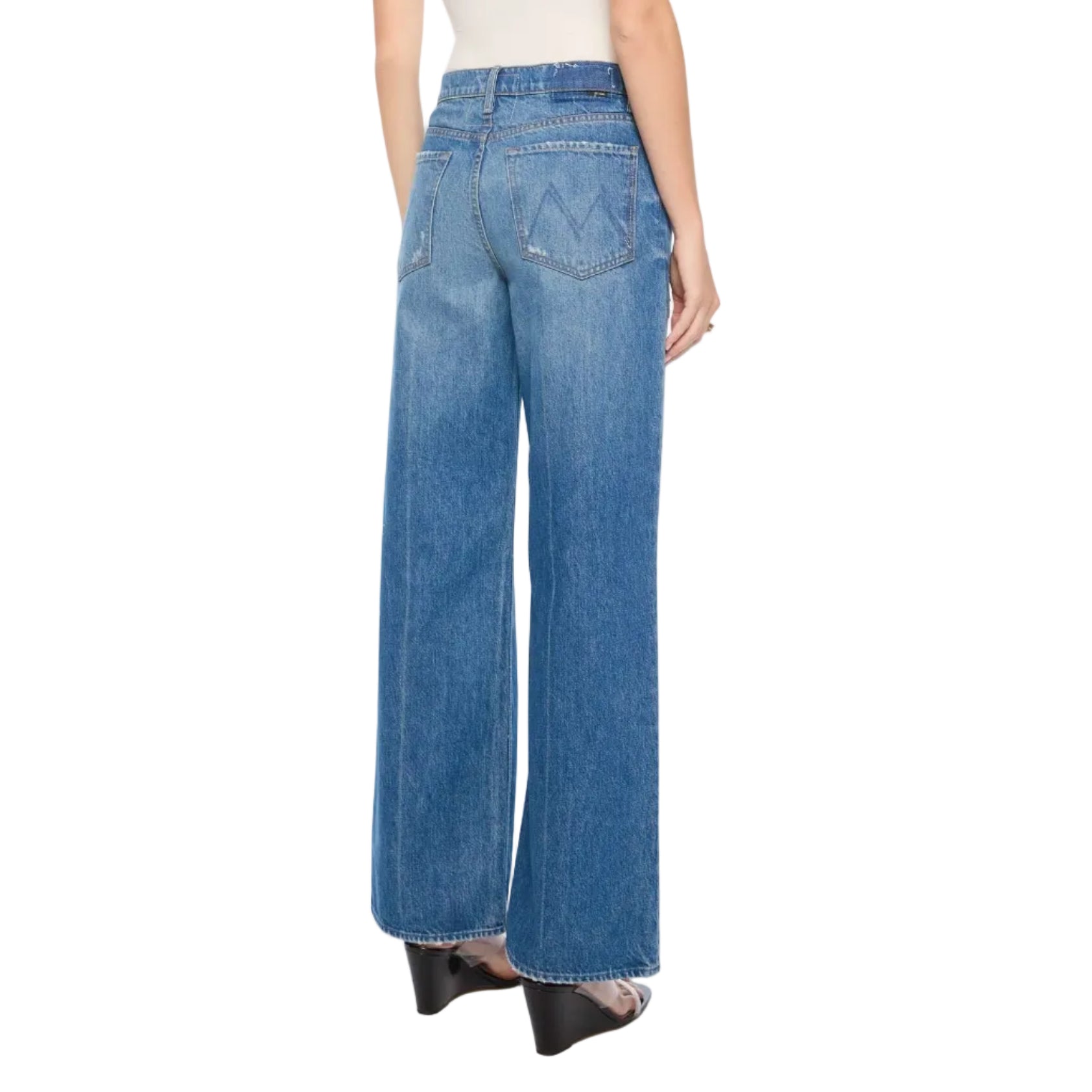 Woman wearing blue jeans and a white top on a white background