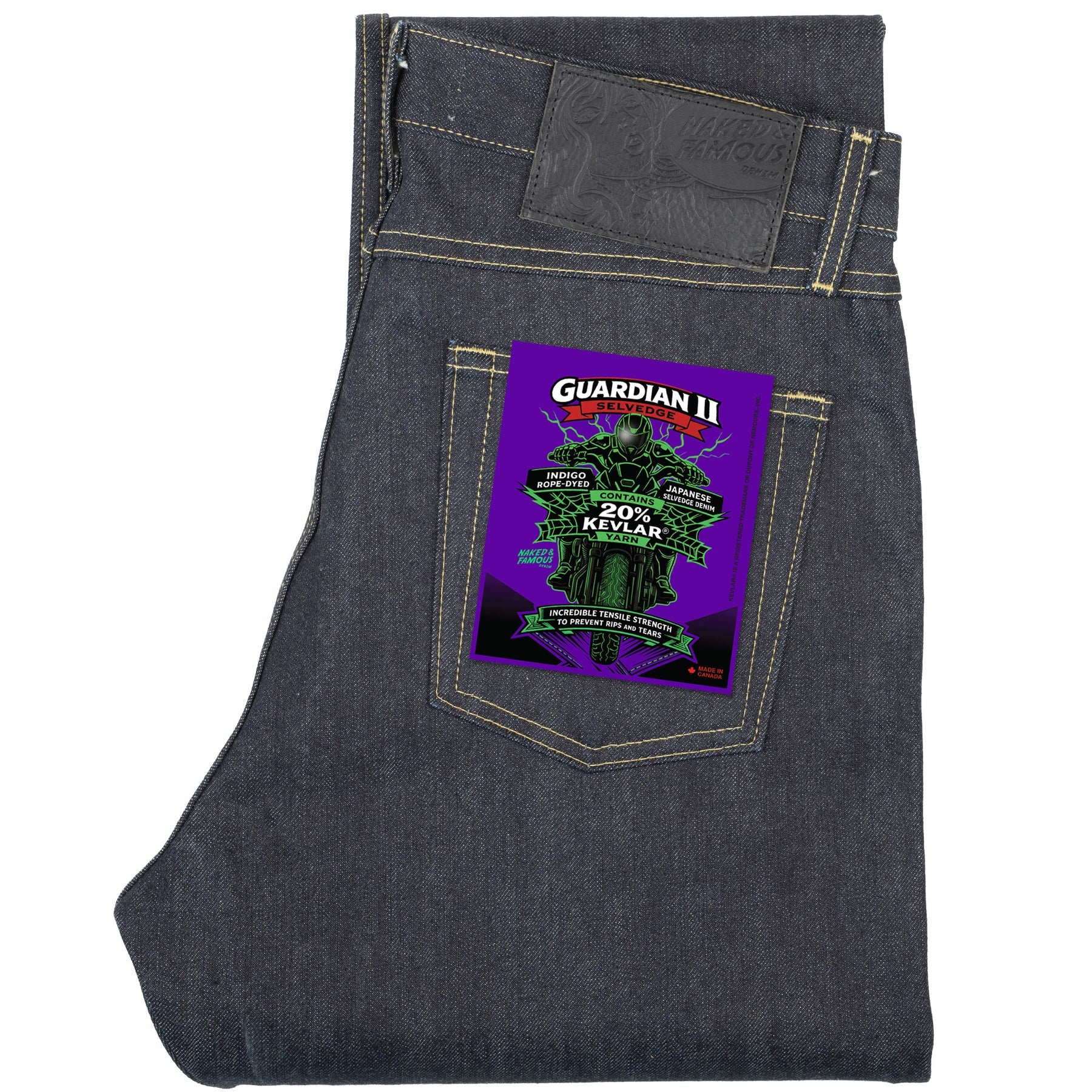 Dark indigo denim jeans folded flat, featuring a vibrant purple and green 'Guardian II' patch on the back pocket.