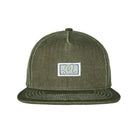 An olive green snapback cap with a white rectangular patch on the front featuring a stylized 'M' logo, shown against a plain white background.