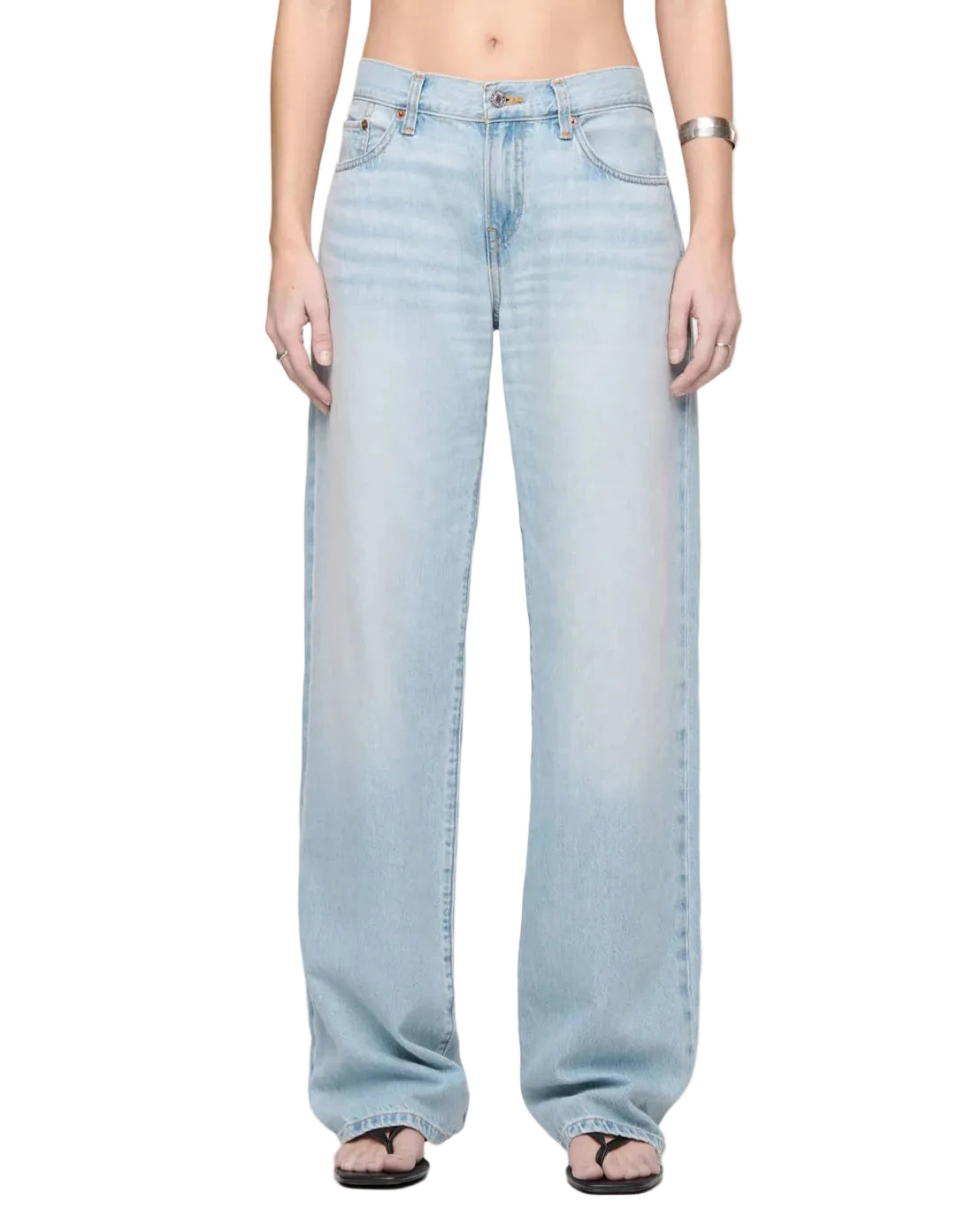 Model wearing light blue wash denim jeans by RE/DONE, low-rise straight-leg fit, styled with sandals, shown from waist down against a white background.