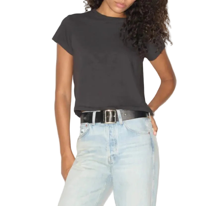 A model wearing a black short-sleeve t-shirt, light-wash distressed jeans, and a black belt, standing against a white background.