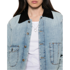 Close-up of the Canyon Jacket worn open over a white T-shirt, showing the corduroy collar, metal buttons and front patch pockets.