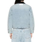 Back view of the Canyon Jacket on a model, showing the cropped hem, the brown corduroy collar and a label patch below the collar.