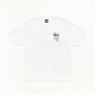 A white Stussy short-sleeve t-shirt with a small black and gray graphic on the left chest, laid flat against a clean white background.