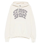 An off-white pullover hoodie featuring the words 'STUSSY SPORT' printed in a gray varsity-style font across the chest, displayed on a clean white background.
