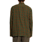 Back view of the School Shirt on a model, showing the oversized fit, dropped shoulders and crinkled plaid fabric.