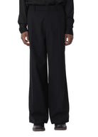 Person wearing a black outfit on a white background