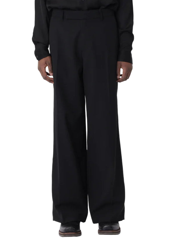 Person wearing a black outfit on a white background