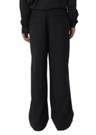 Person wearing a black outfit on a white background