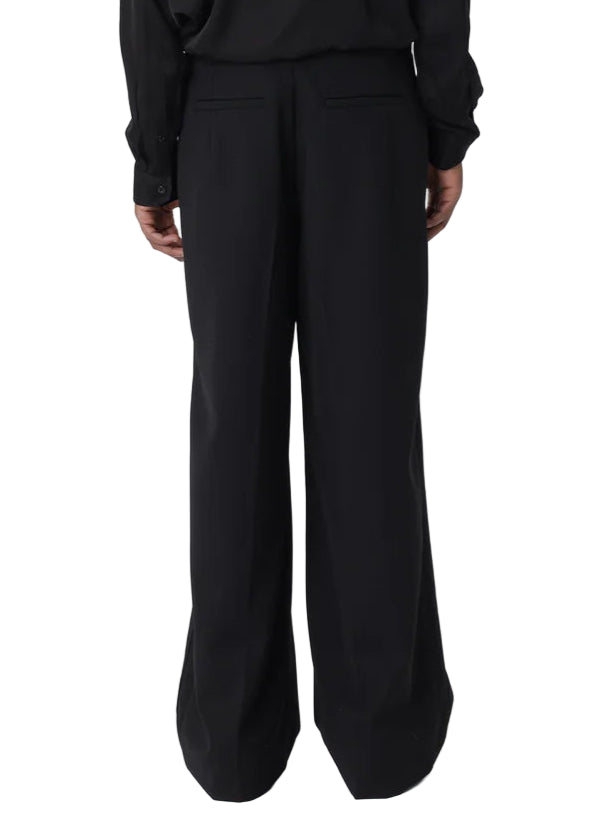 Person wearing a black outfit on a white background