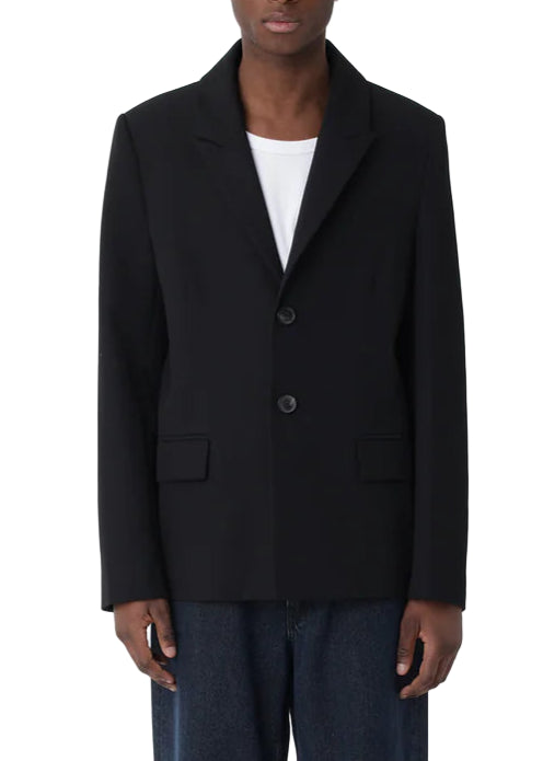 Person wearing a black blazer on a white background