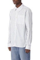 Man wearing a white striped shirt and blue jeans on a white background