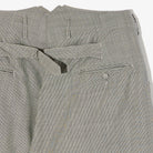 Close-up of gray checkered pants with a white background
