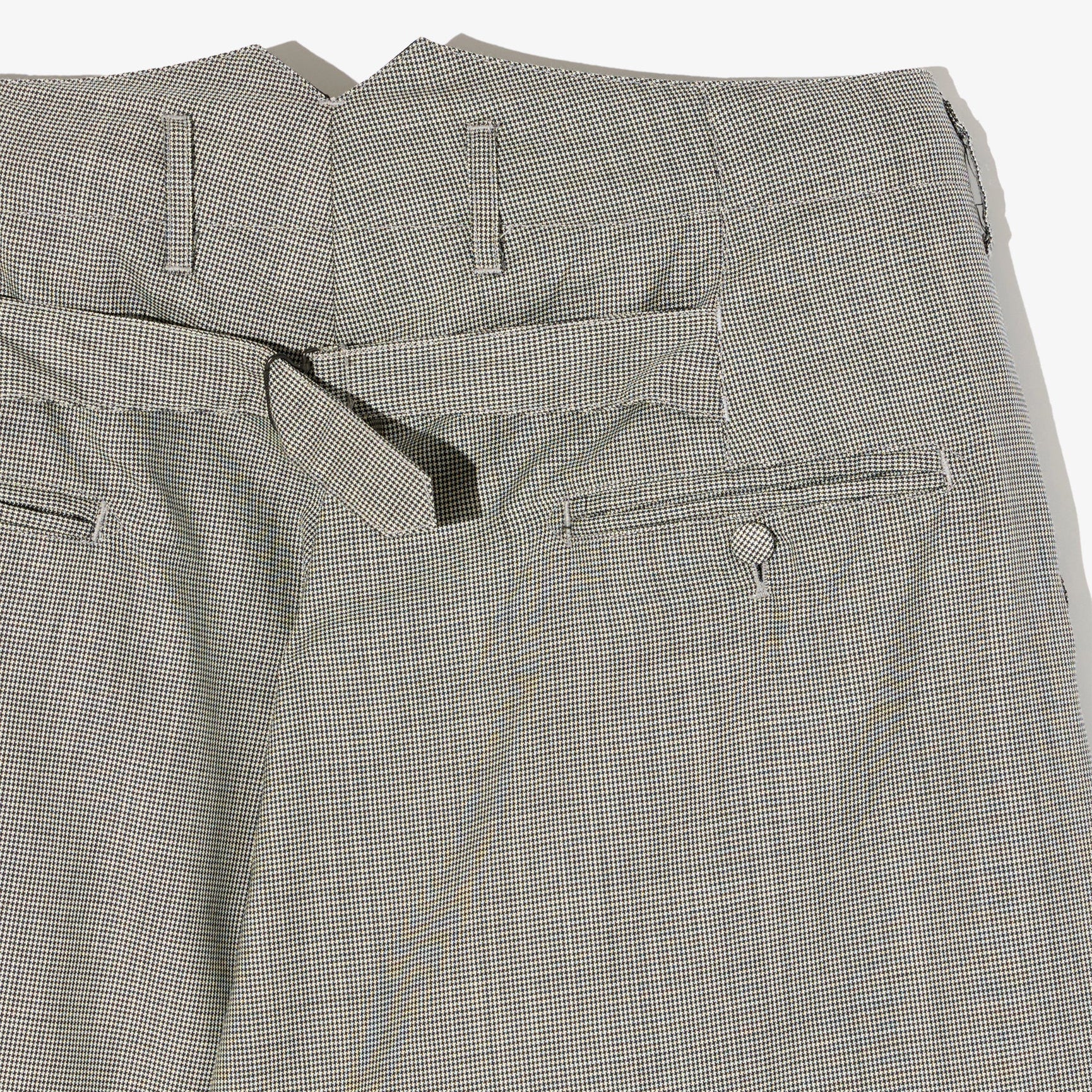 Close-up of gray checkered pants with a white background