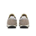 Pair of beige Saucony sneakers on a white background