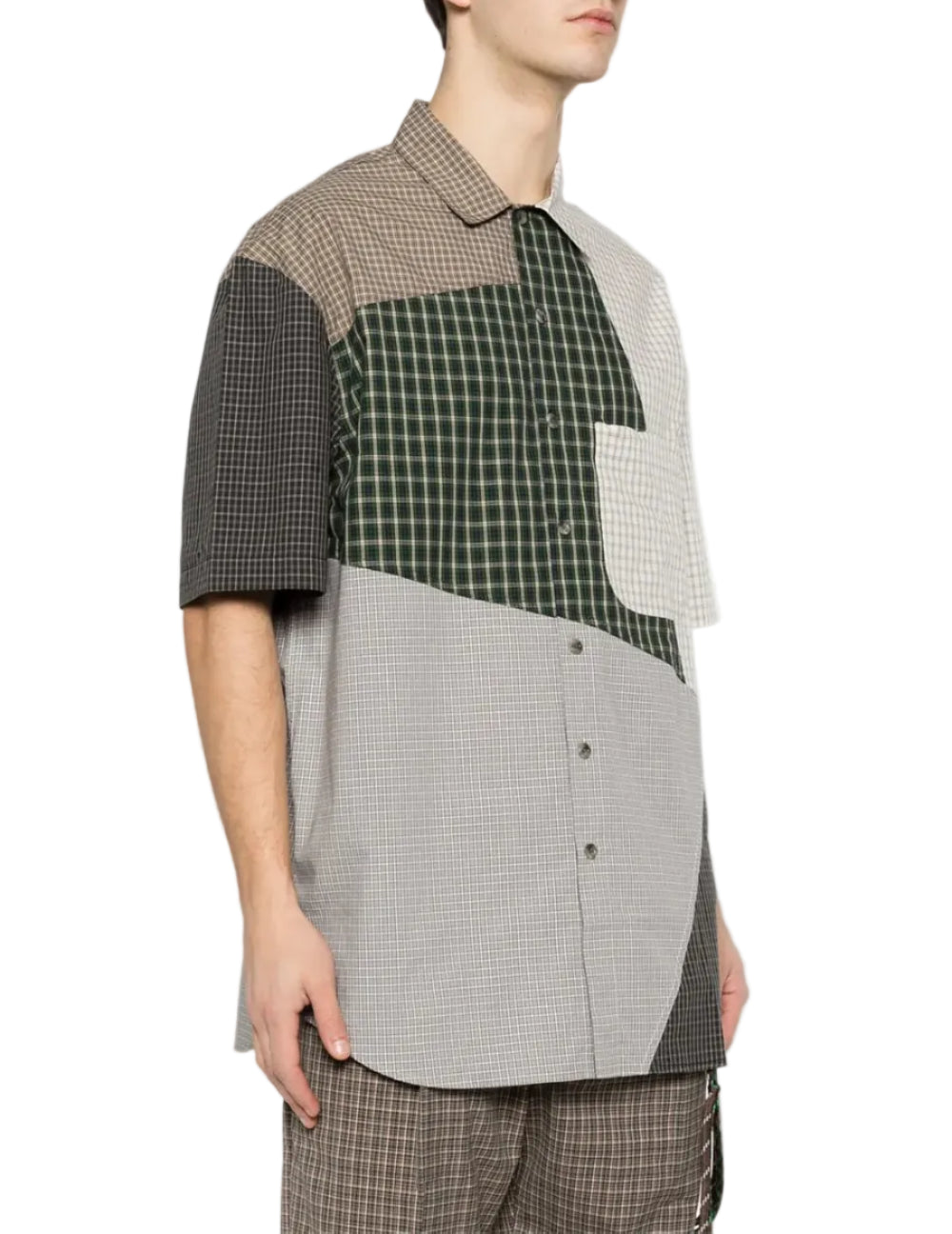 Person in a short sleeved button down shirt in multi-colorblock check on a white background