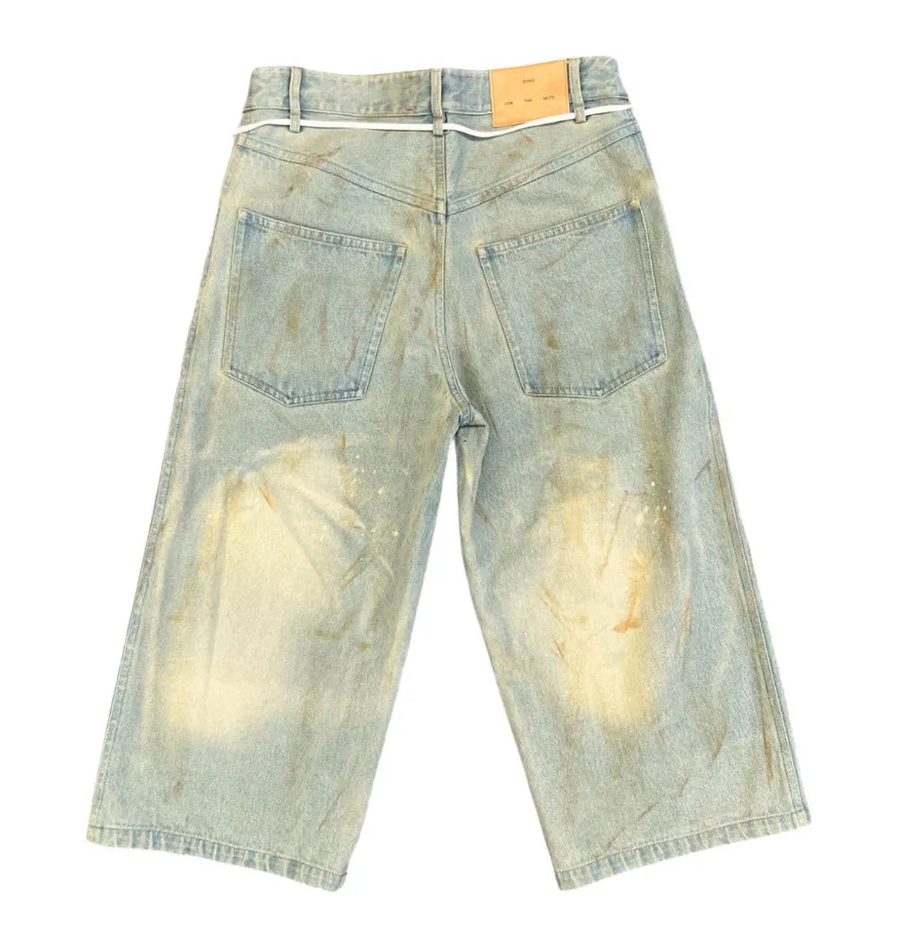 Back view of long denim jean shorts on a white background