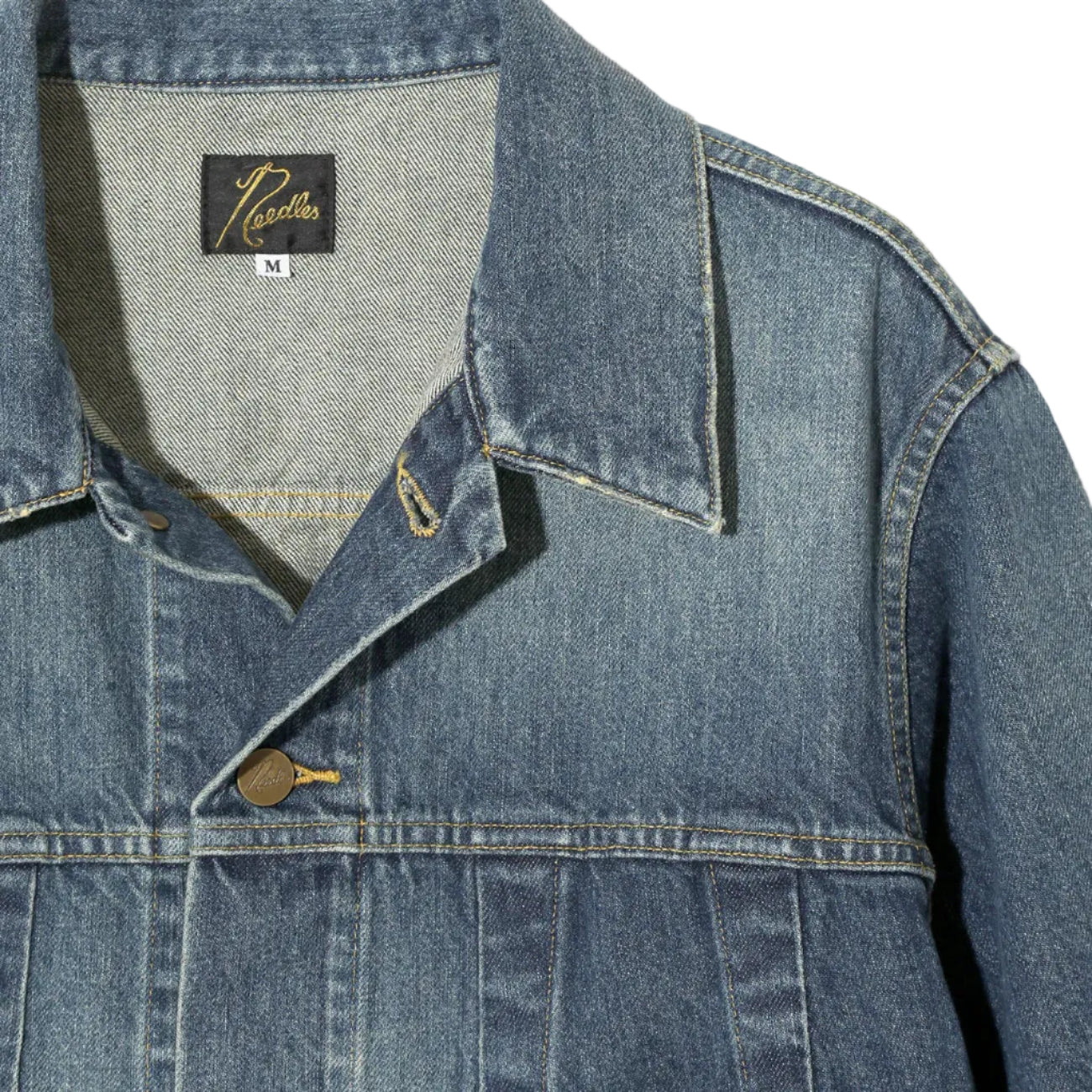 Close-up of a blue denim jacket with a brand label on a white background