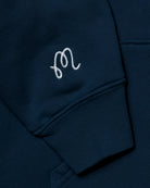 Navy blue sweatshirt with a white embroidered logo on the chest pocket.