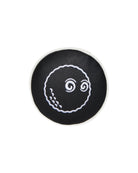 Black round coaster with white octopus design on a white background