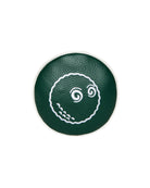Green circular object with a white design on a white background