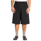 Person wearing black shorts on a white background