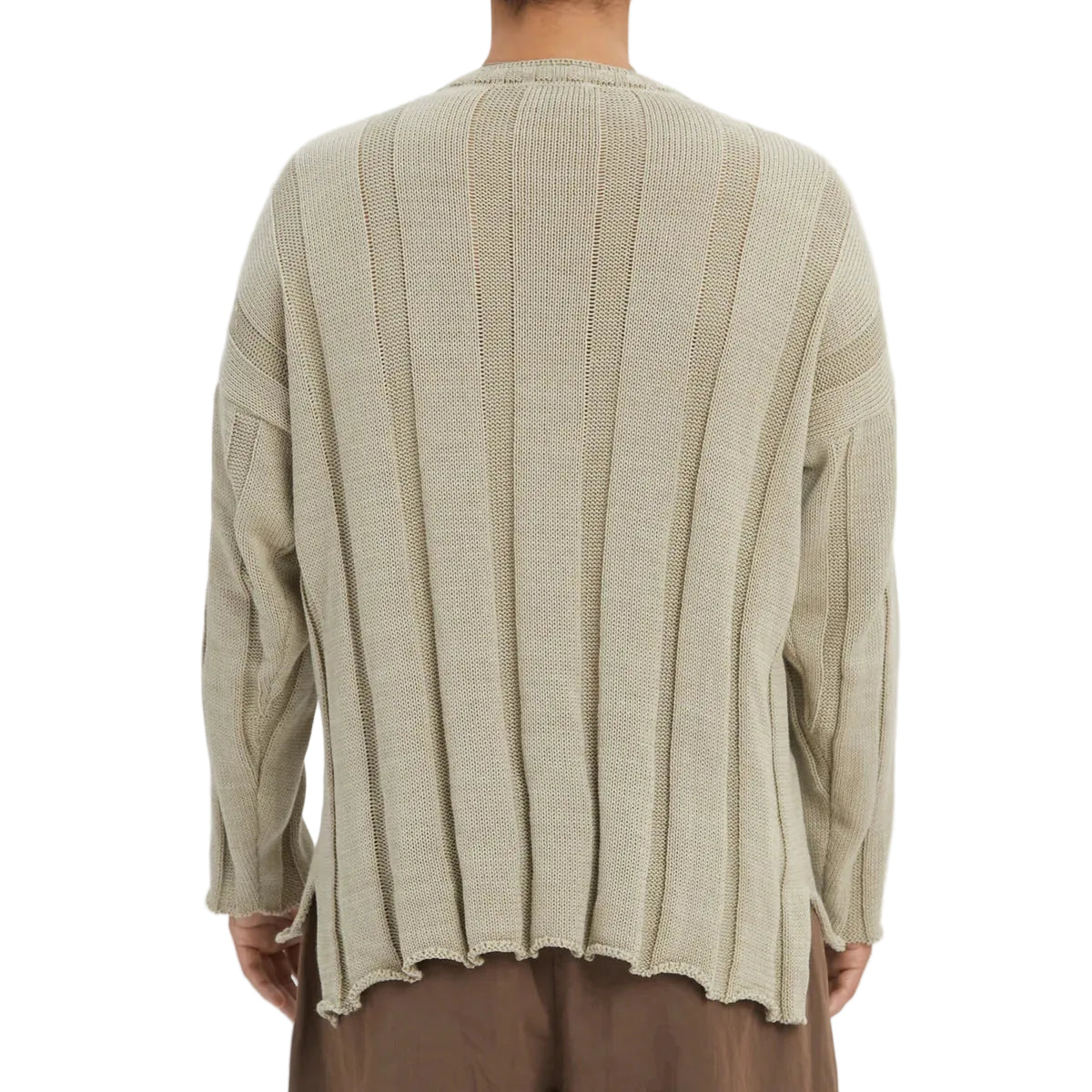 Beige ribbed sweater worn by a person on a white background