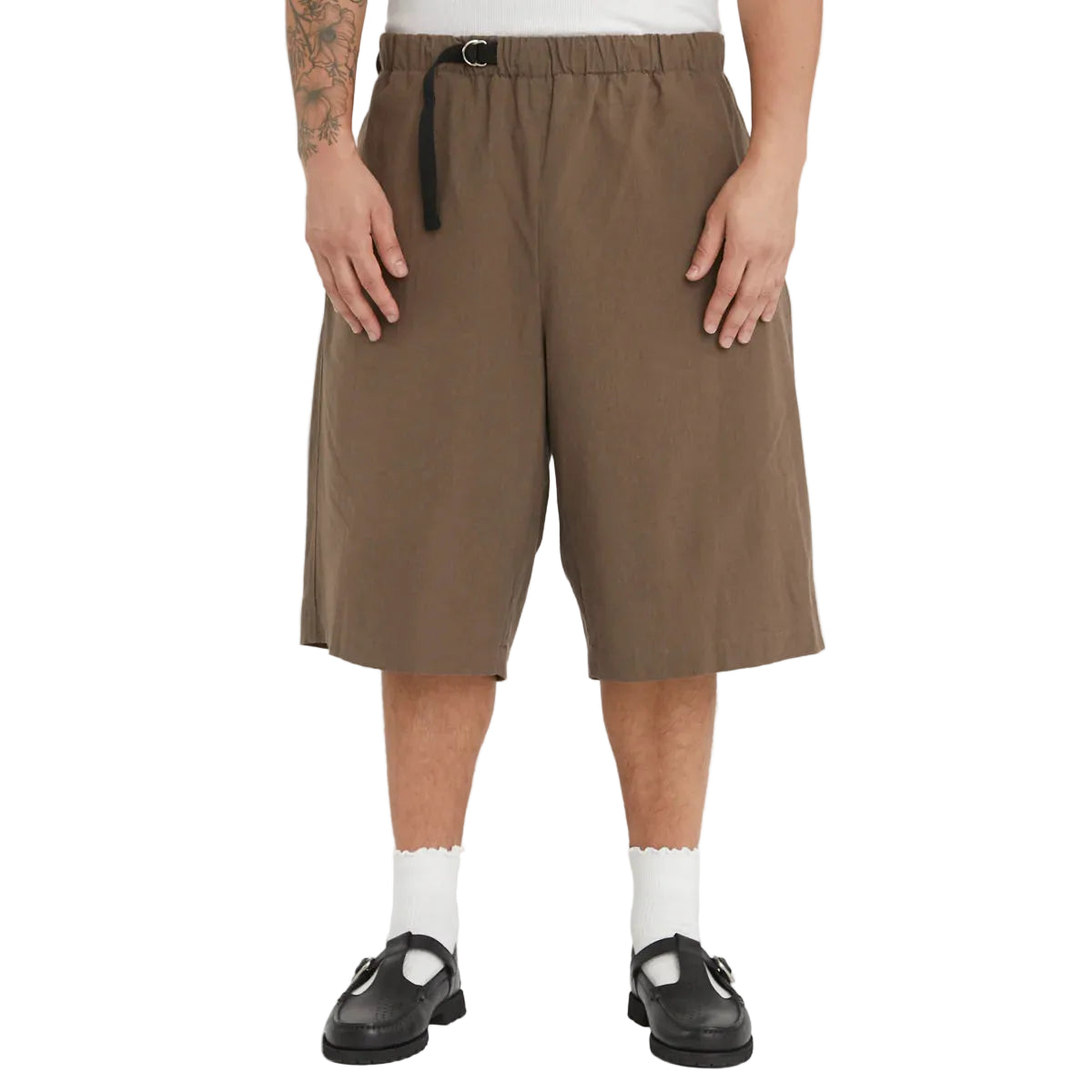 Person wearing brown shorts on a white background