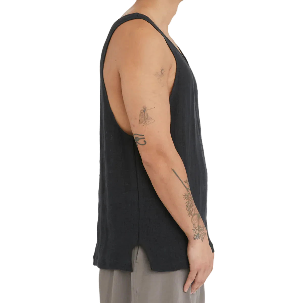 Person wearing a black sleeveless top on a white background
