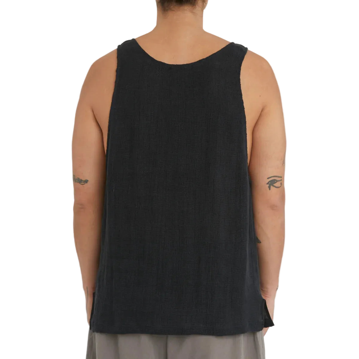 Person wearing a black tank top on a plain background