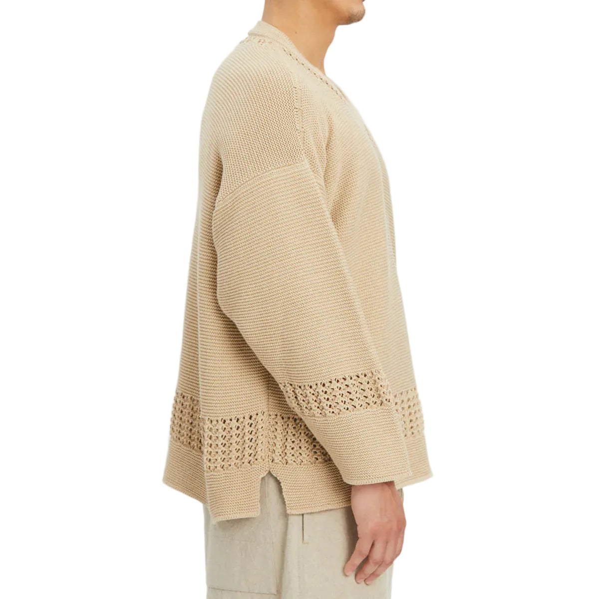 Beige knitted cardigan with lace trim on a white background