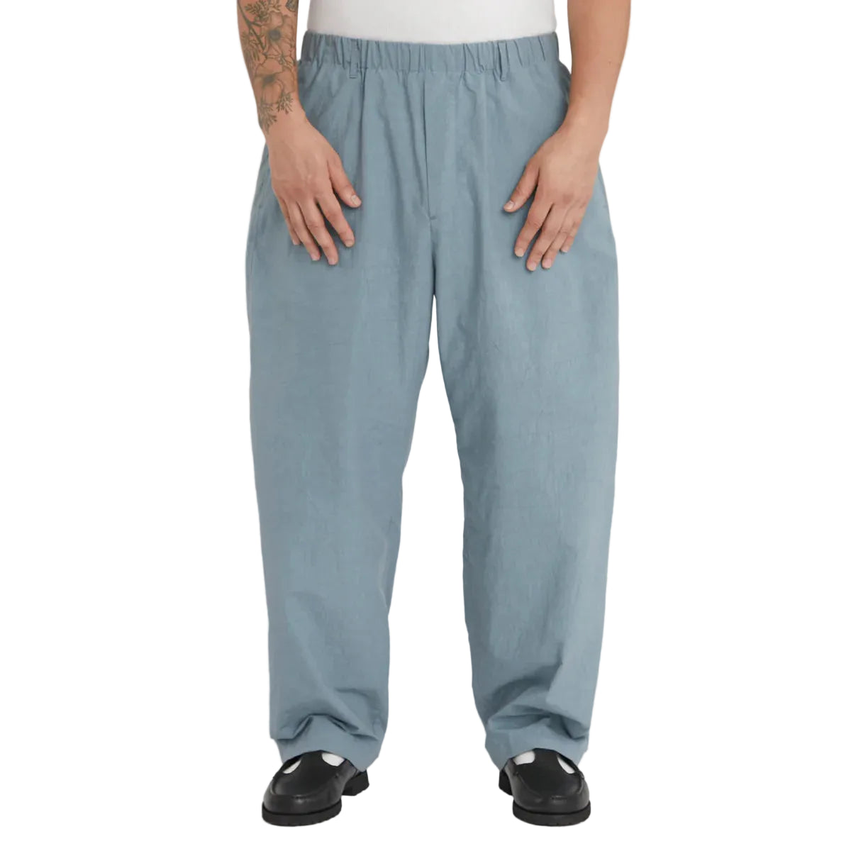 Person wearing light blue pants on a white background