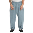 Person wearing light blue pants on a white background