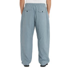 Light blue pants worn by a person on a white background