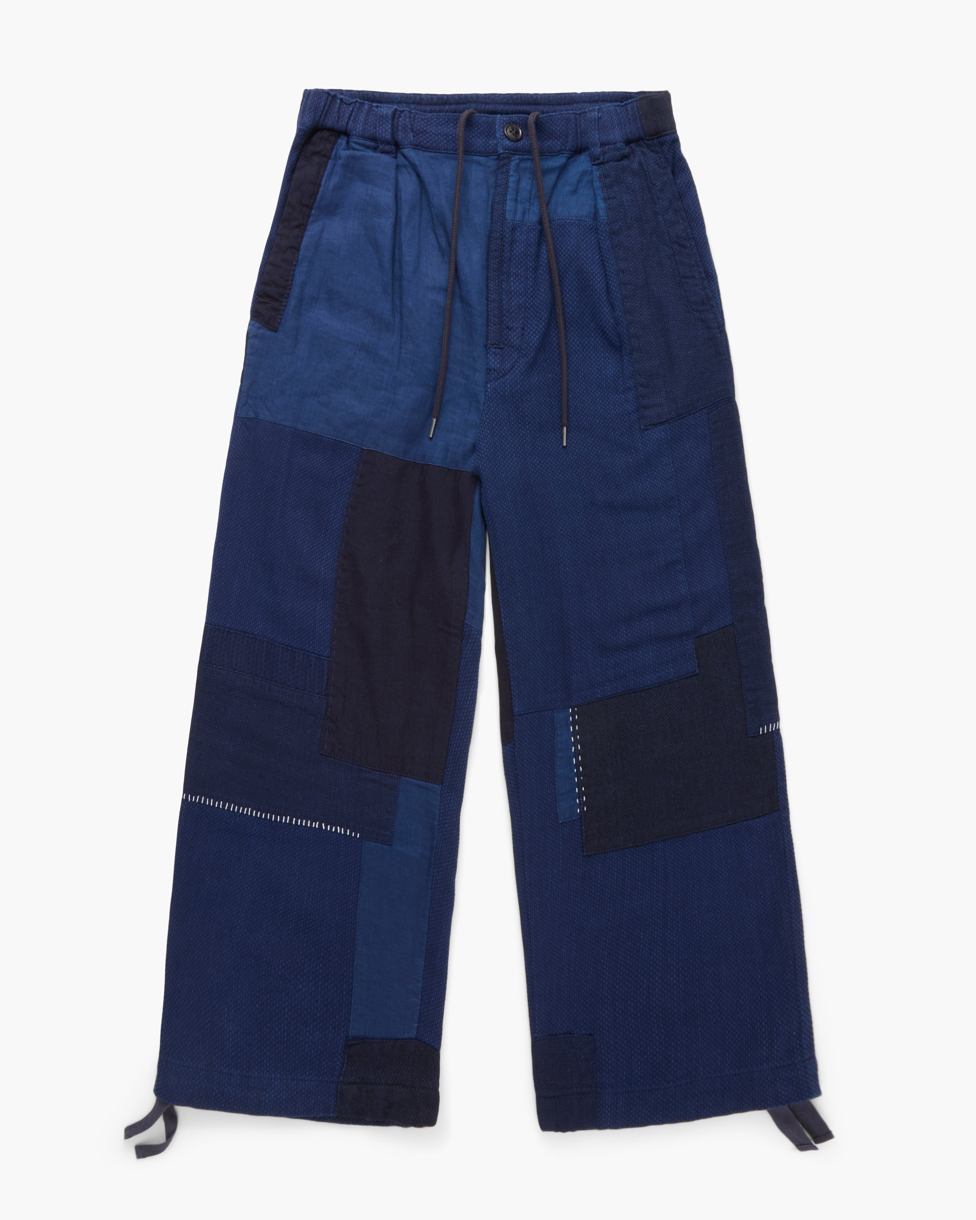 Navy blue patchwork pants on a white background
