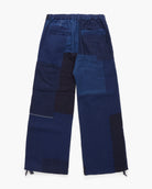 Navy blue pants with patchwork design on a white background