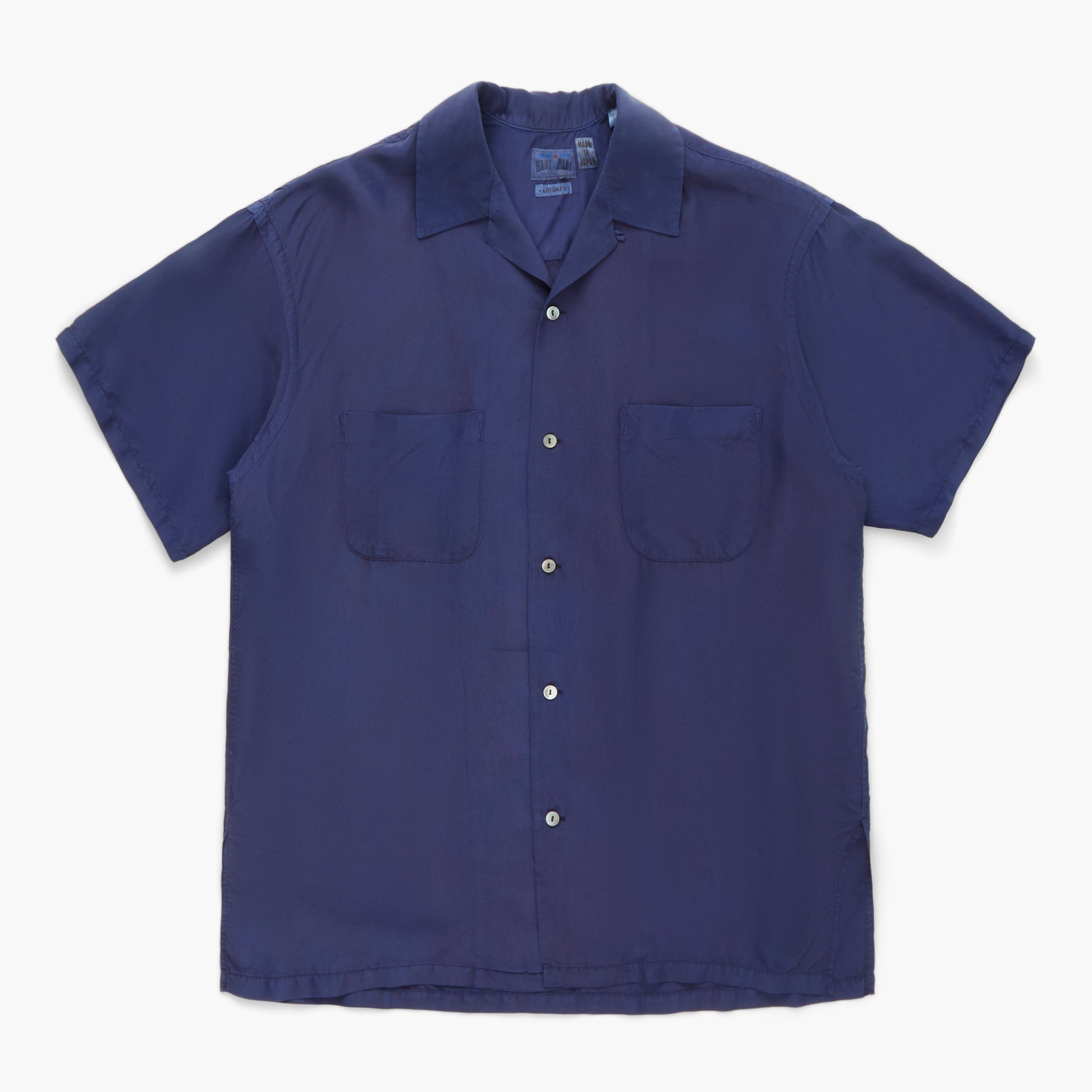 Navy blue short-sleeve shirt with two front pockets on a white background