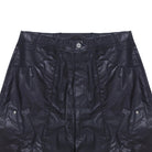 Close-up of dark blue pants with a button on a white background