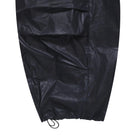 close-up of leg opening for waxed navy pants on a white backround