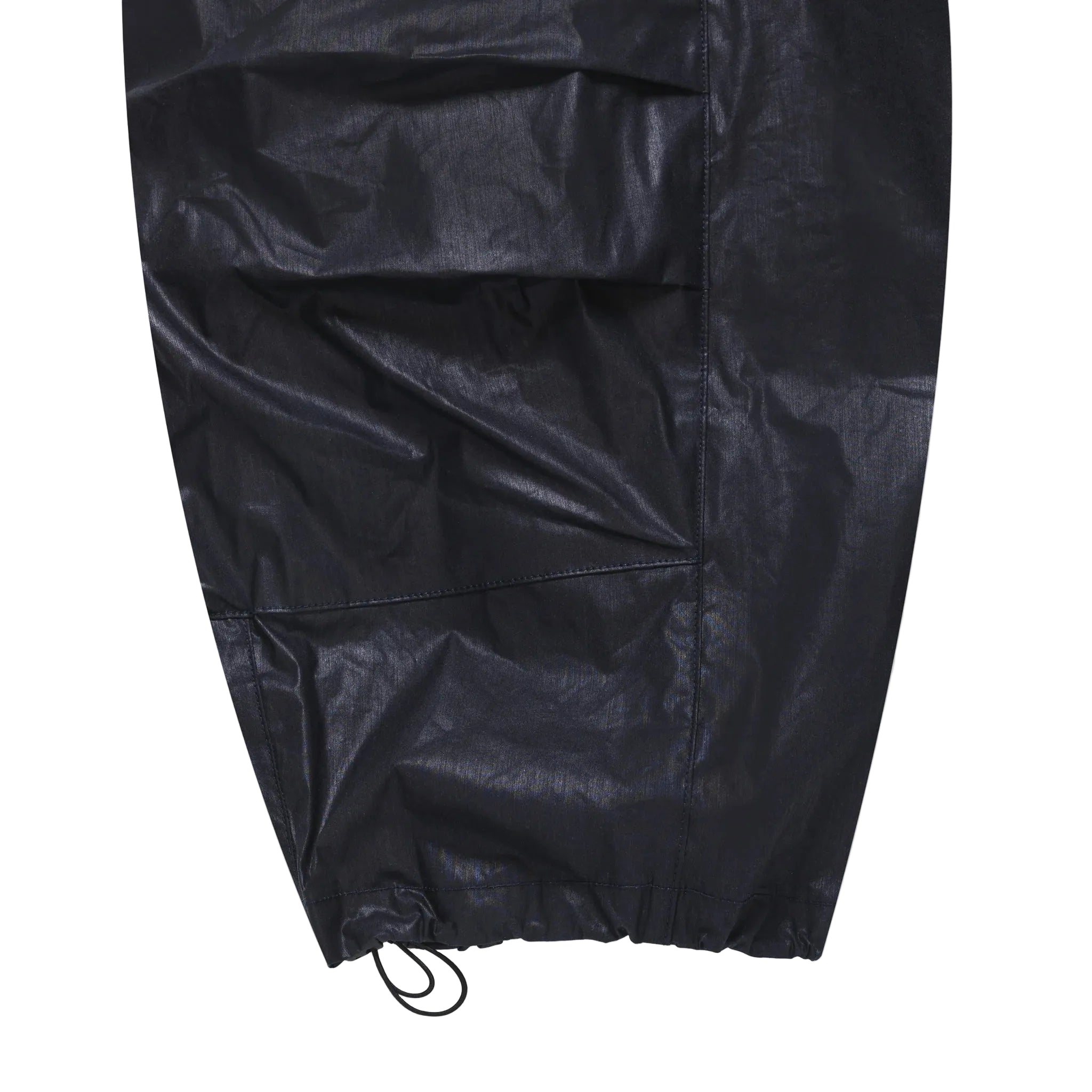 close-up of leg opening for waxed navy pants on a white backround