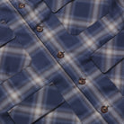 Close-up of a blue plaid shirt with buttons