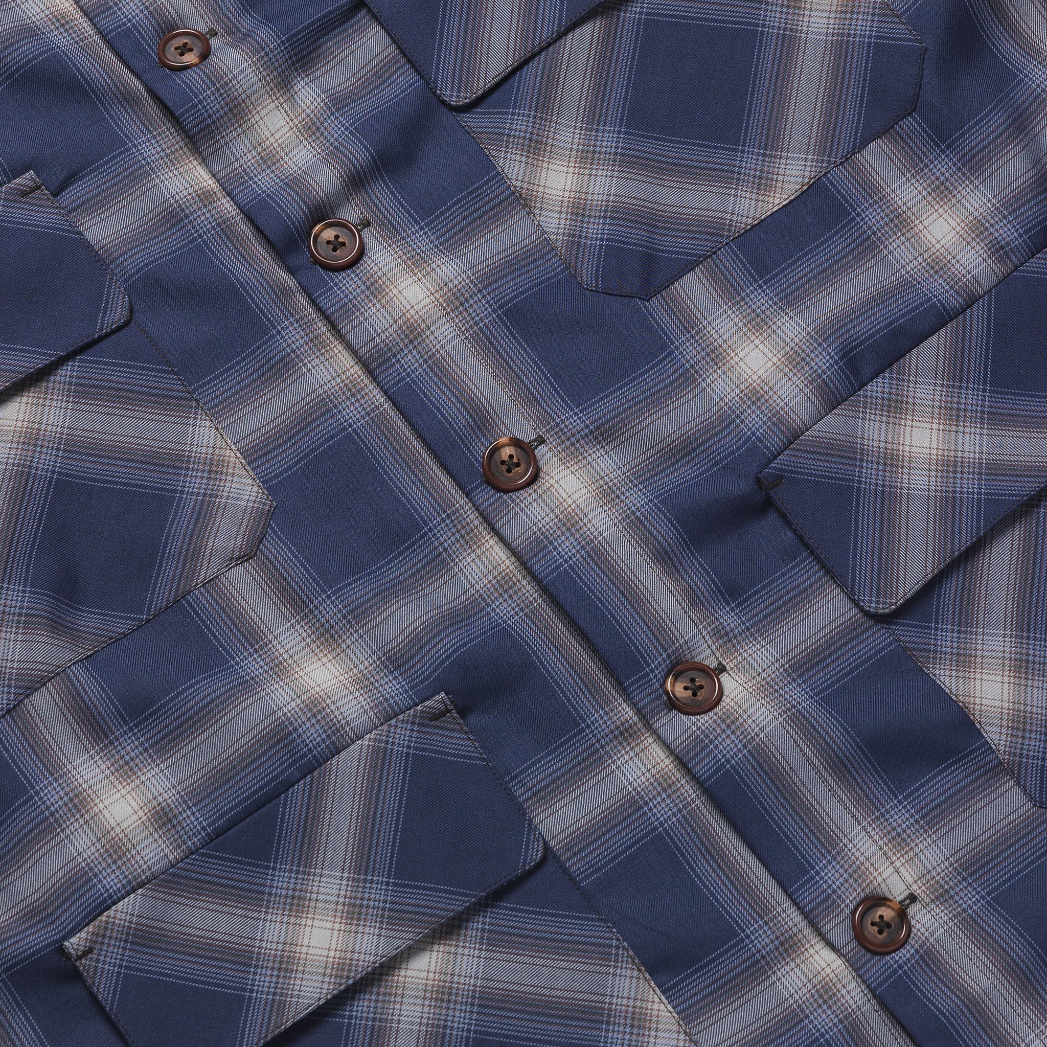 Close-up of a blue plaid shirt with buttons