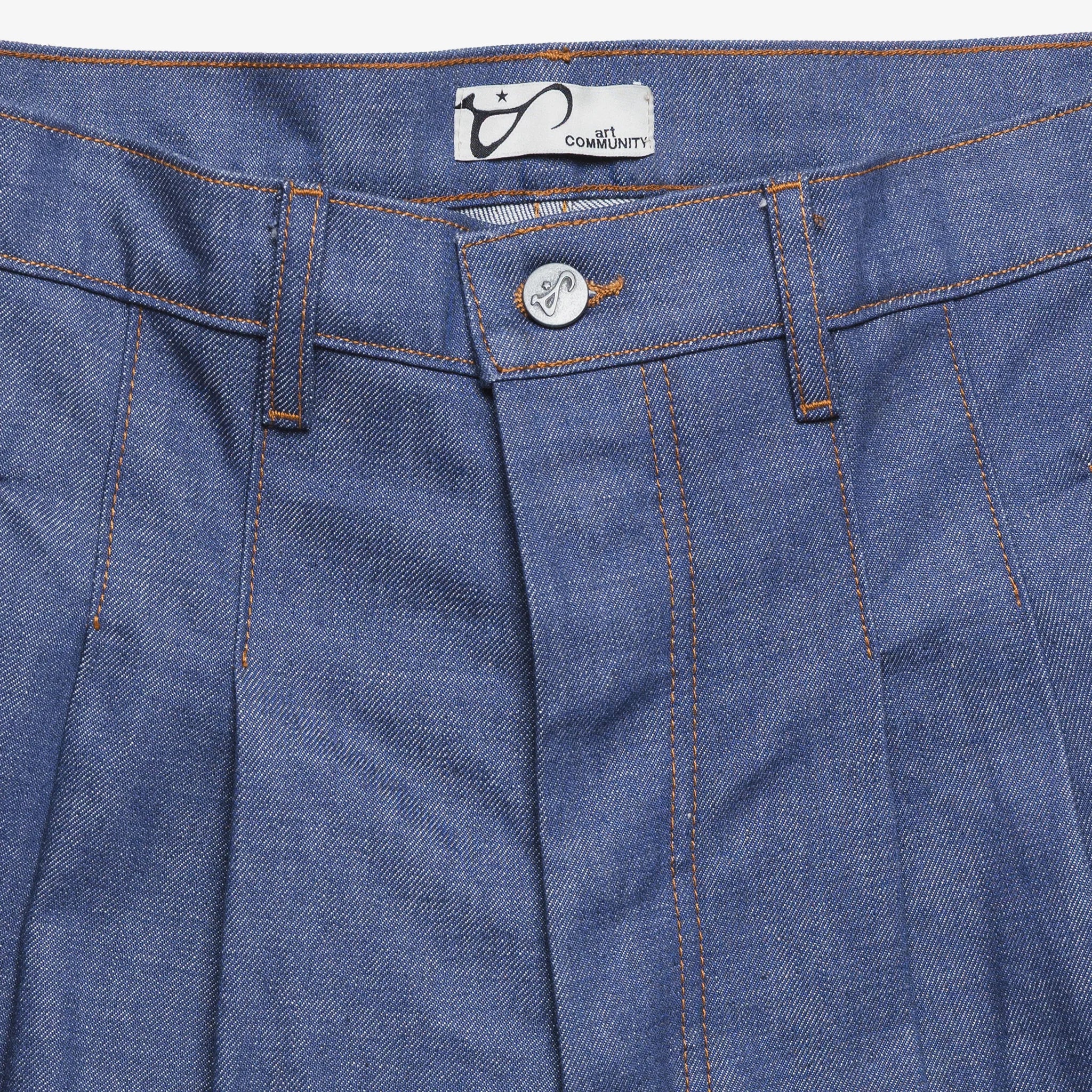 Close-up of blue denim pants with a brand label on the pocket.