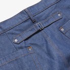 Close-up of blue denim shorts with a belt and stitching details.
