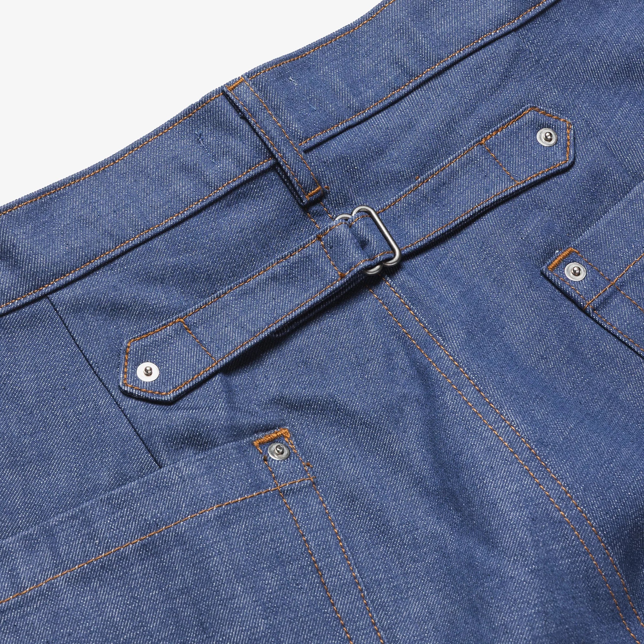 Close-up of blue denim shorts with a belt and stitching details.