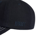 navy cap with 'KROST' branding on a white background