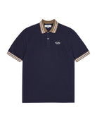 Navy polo shirt with brown and beige trim on a white background