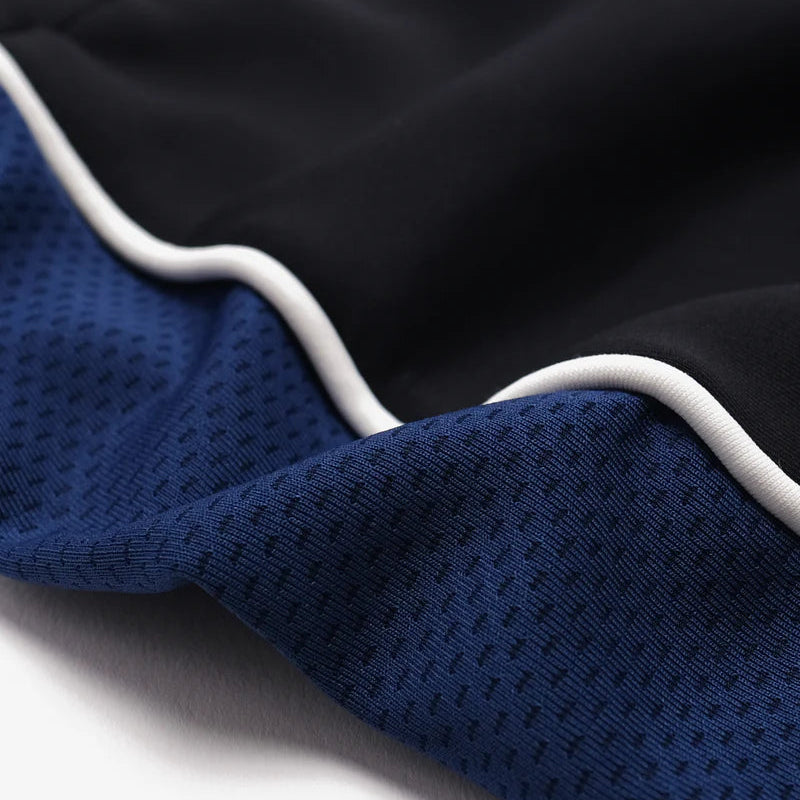 Close-up of black and blue fabric with white trim on a white background