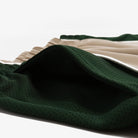 Close-up of green fabric with a textured pattern on a white background