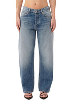 Blue jeans worn by a person on a white background